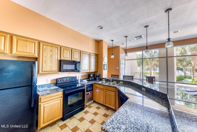 kitchen featuring black appliances, sink, a textured ceiling, decorative light fixtures, and dark stone counters