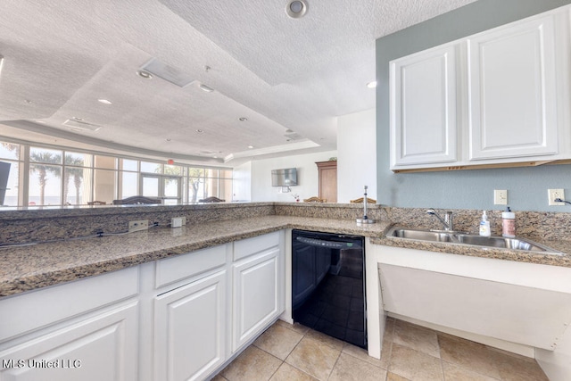 kitchen featuring black dishwasher, white cabinetry, a textured ceiling, stone countertops, and sink