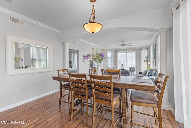 dining space featuring ceiling fan, decorative columns, and hardwood / wood-style floors