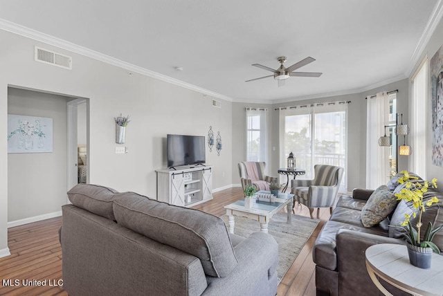 living room featuring crown molding, wood-type flooring, and ceiling fan