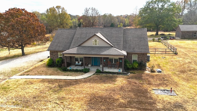 view of front of home featuring a porch and a front yard