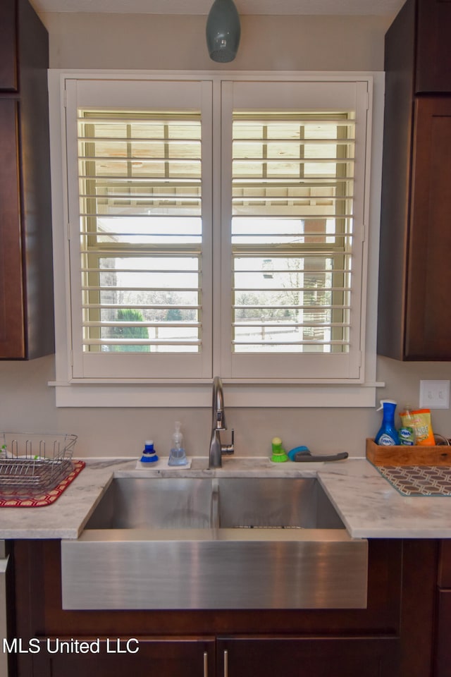 kitchen featuring sink and dark brown cabinets