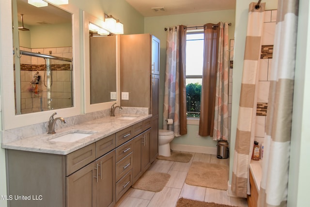 bathroom featuring vanity, a shower with shower door, toilet, and tile patterned floors