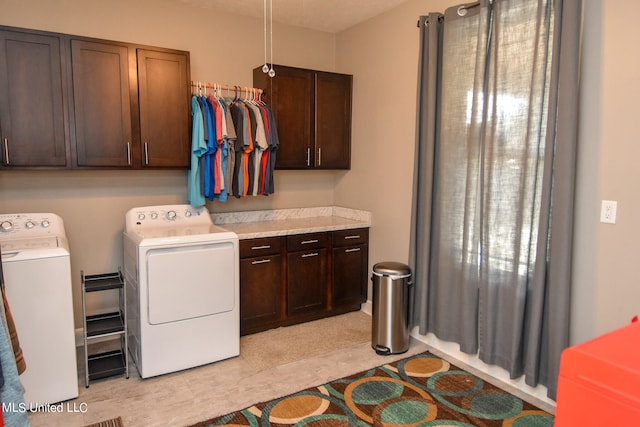 laundry room featuring independent washer and dryer and cabinets