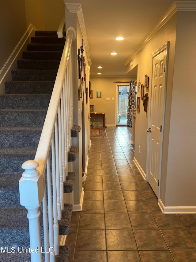 staircase with ornamental molding and tile patterned flooring