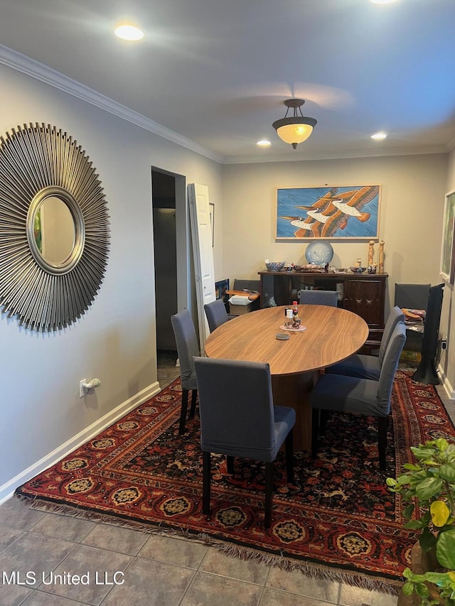 dining space with tile patterned flooring and ornamental molding