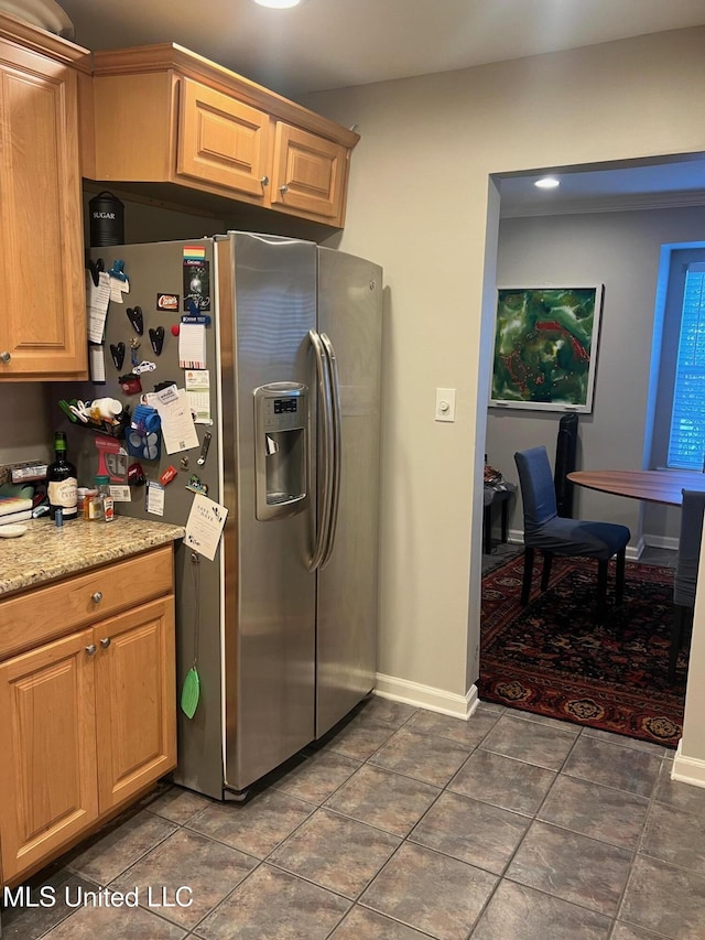 kitchen with stainless steel fridge with ice dispenser and dark tile patterned floors