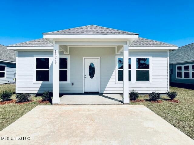 view of exterior entry with a lawn