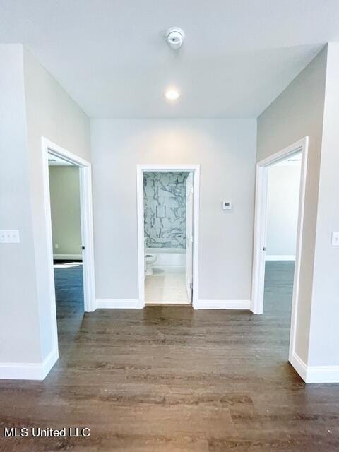 corridor with dark hardwood / wood-style floors