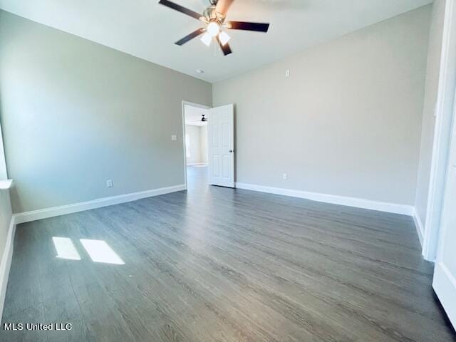 spare room with ceiling fan and dark hardwood / wood-style flooring