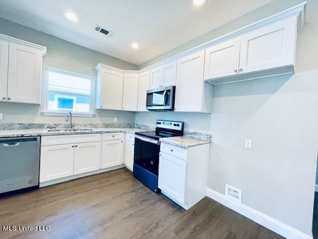 kitchen featuring white cabinetry, appliances with stainless steel finishes, and sink