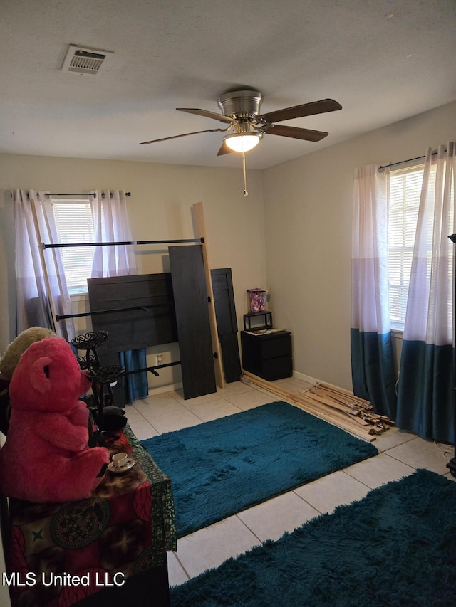 interior space featuring light tile patterned floors and visible vents