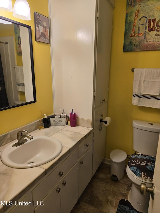 bathroom featuring toilet and vanity