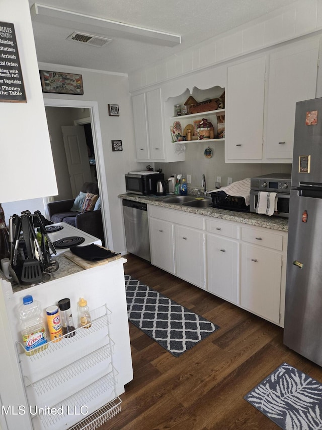 kitchen featuring visible vents, stainless steel appliances, light countertops, white cabinetry, and open shelves