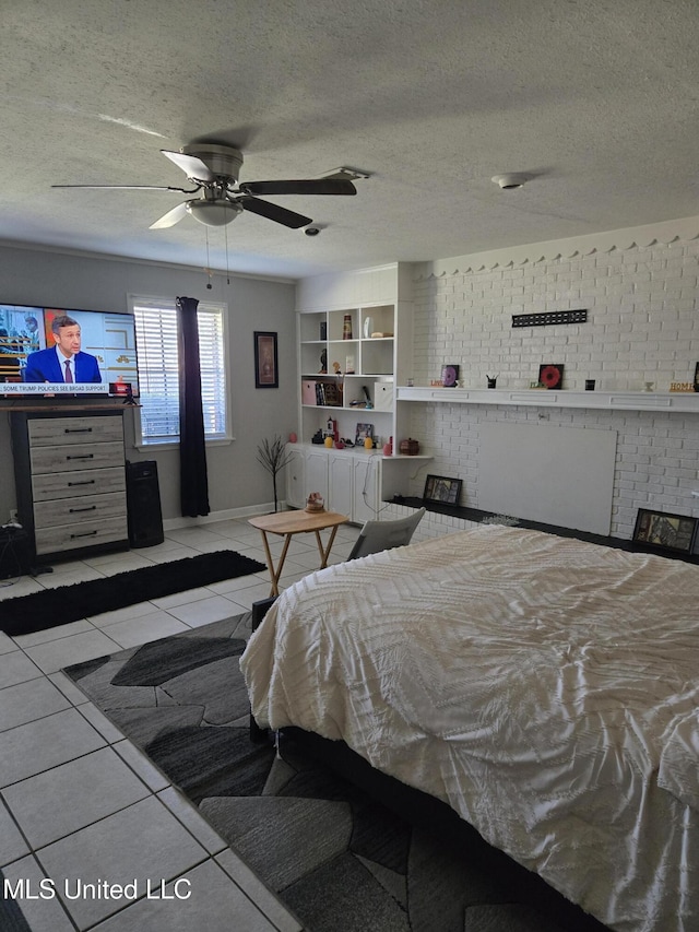 bedroom with light tile patterned floors, ceiling fan, a textured ceiling, and a fireplace