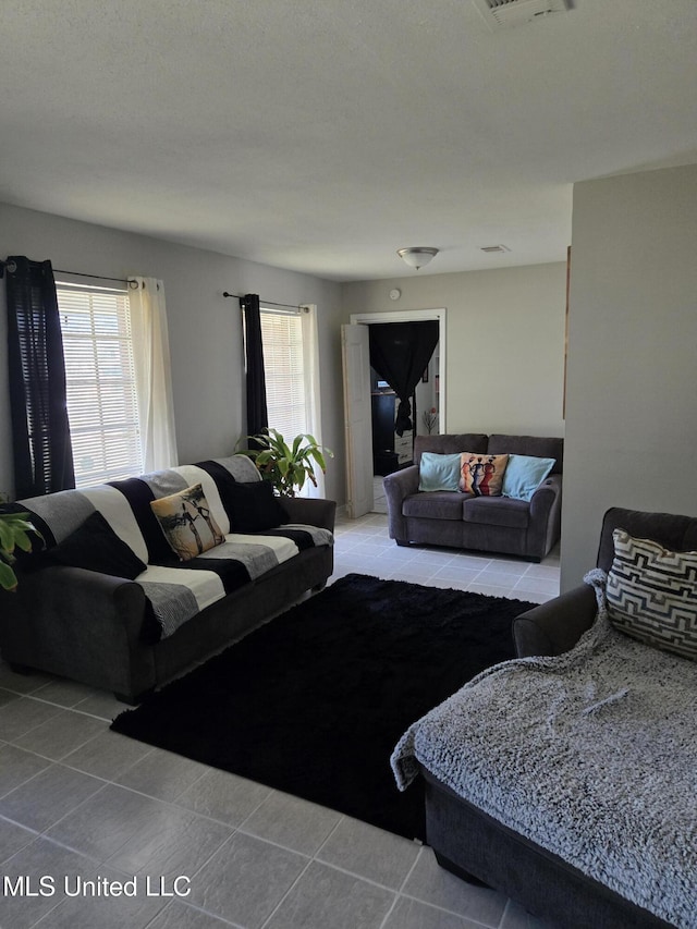 living area featuring a healthy amount of sunlight and light tile patterned floors