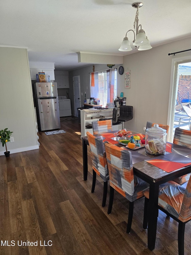 dining room featuring a healthy amount of sunlight, washer / dryer, and dark wood finished floors