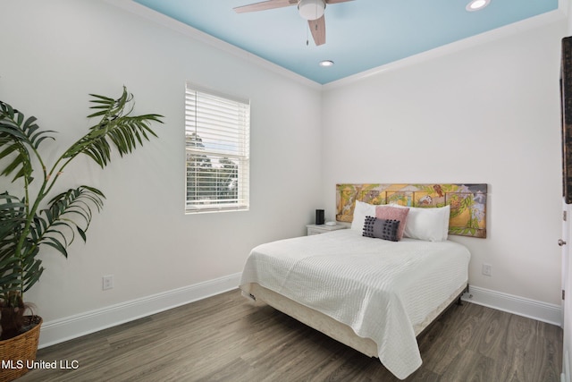 bedroom featuring dark wood-type flooring, ceiling fan, and crown molding