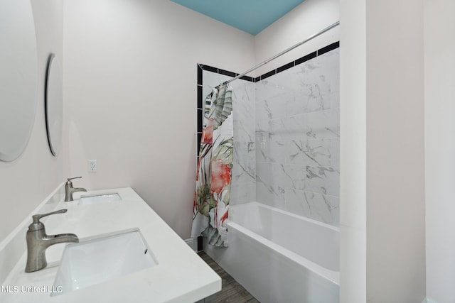 bathroom featuring hardwood / wood-style flooring, sink, and shower / bathtub combination with curtain