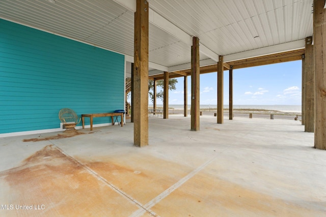 view of patio / terrace with a water view and a view of the beach