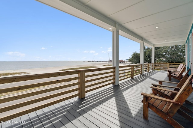 deck with a beach view and a water view