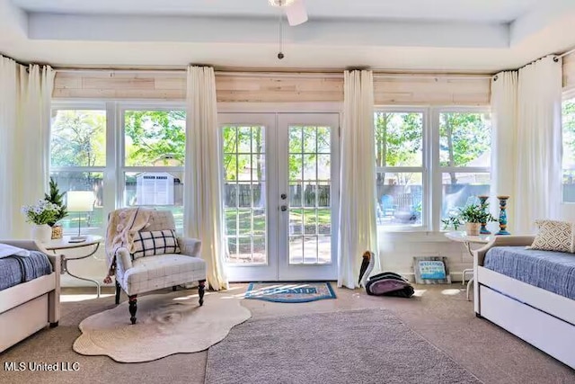 carpeted bedroom featuring multiple windows, access to outside, french doors, and ceiling fan