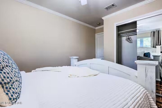 bedroom featuring ornamental molding and a closet