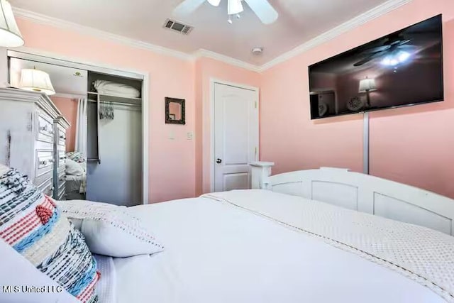 bedroom with ornamental molding, ceiling fan, and a closet