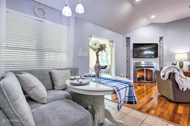 living room with lofted ceiling and light tile patterned floors