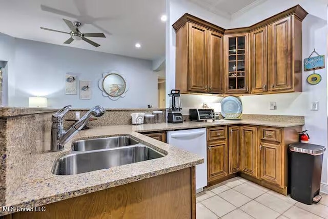 kitchen with sink, ceiling fan, dishwasher, light stone countertops, and light tile patterned flooring