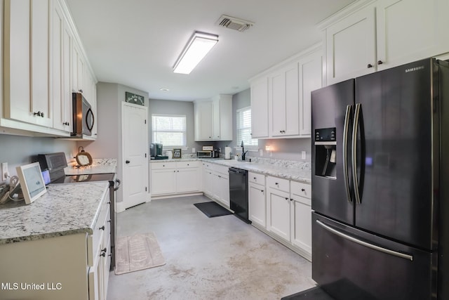 51 Decalb Oneal Rd, Perkinston, MS 39573 - kitchen featuring stainless steel appliances, concrete flooring, and white cabinets