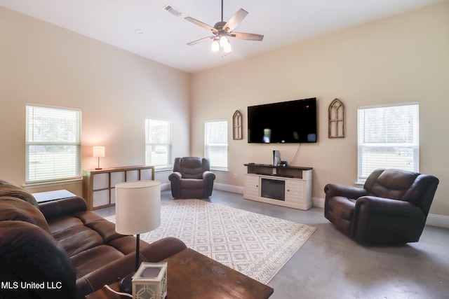 51 Decalb Oneal Rd, Perkinston, MS 39573 - living area featuring healthy amount of natural light, ceiling fan, carpet, baseboards, and a high ceiling
