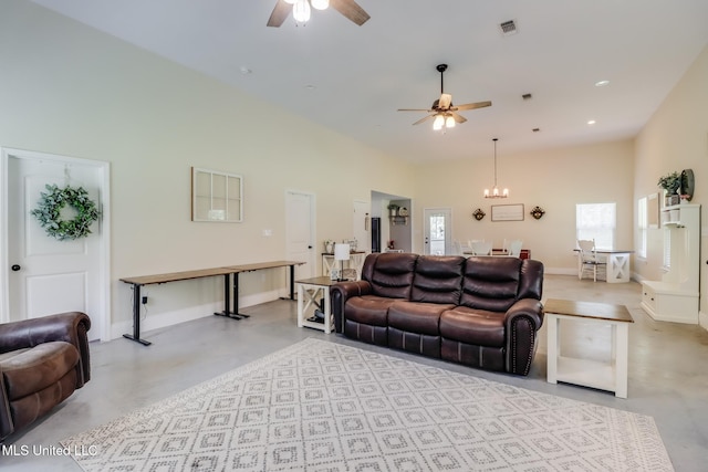 51 Decalb Oneal Rd, Perkinston, MS 39573 - living room featuring a ceiling fan, concrete flooring, baseboards, a chandelier, and a high ceiling