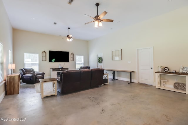 51 Decalb Oneal Rd, Perkinston, MS 39573 - living area featuring finished concrete floors, plenty of natural light, a ceiling fan, baseboards, and a high ceiling