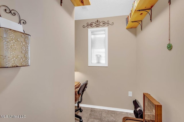 office area with tile patterned floors and baseboards