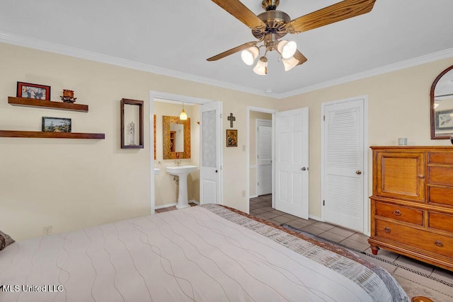 tiled bedroom with ornamental molding, a closet, ceiling fan, and ensuite bath