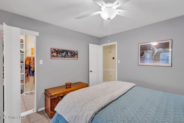 bedroom featuring a ceiling fan, baseboards, and light tile patterned floors