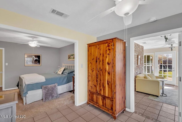 bedroom with light tile patterned floors, ceiling fan, visible vents, and baseboards