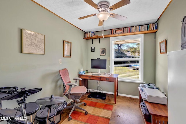 office space with a textured ceiling, a ceiling fan, and baseboards