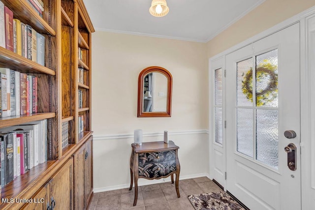 tiled entrance foyer with crown molding and baseboards