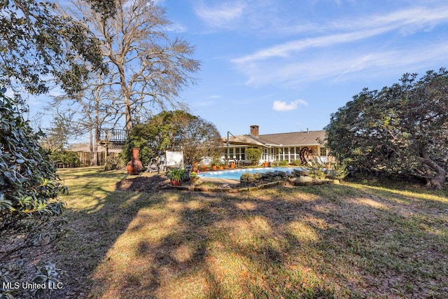 view of yard featuring fence and a fenced in pool