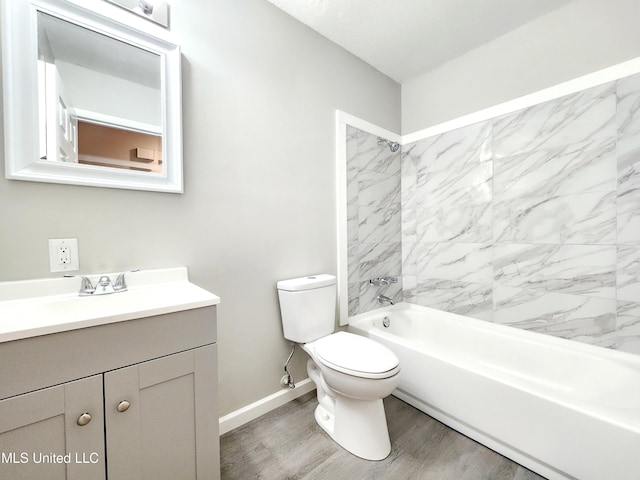 full bath with baseboards, toilet, wood finished floors, vanity, and shower / washtub combination