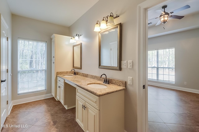 bathroom with ceiling fan, tile patterned floors, and vanity