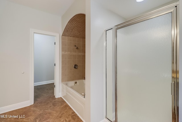 bathroom featuring shower with separate bathtub