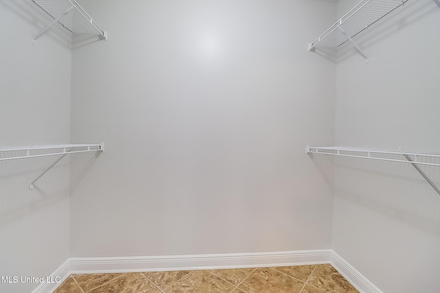 spacious closet with tile patterned flooring