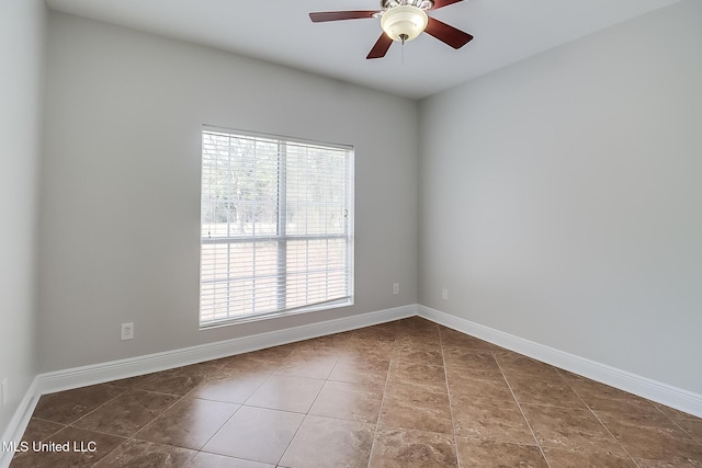 empty room featuring ceiling fan and tile patterned floors