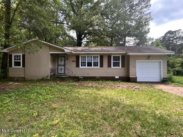 single story home with a garage and a front yard