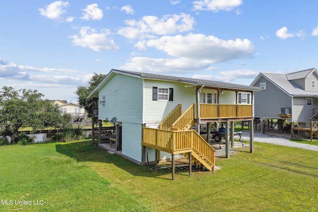 back of house featuring a yard and a deck