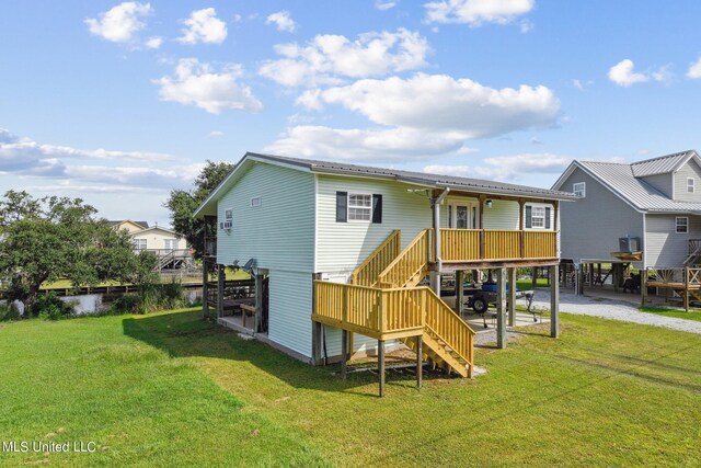 10167 Lagan St, Bay Saint Louis, MS 39520 - back of property featuring stairway, a yard, gravel driveway, and a carport