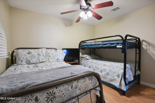 bedroom with ceiling fan and wood-type flooring